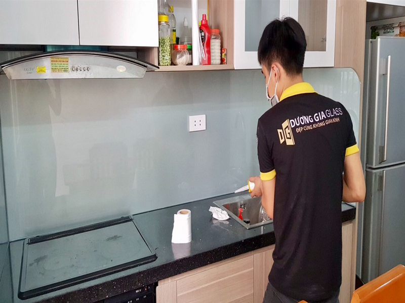 Sự tỉ mỉ của nhân viên bơm keo khi lắp kính chịu nhiệt ốp bếp